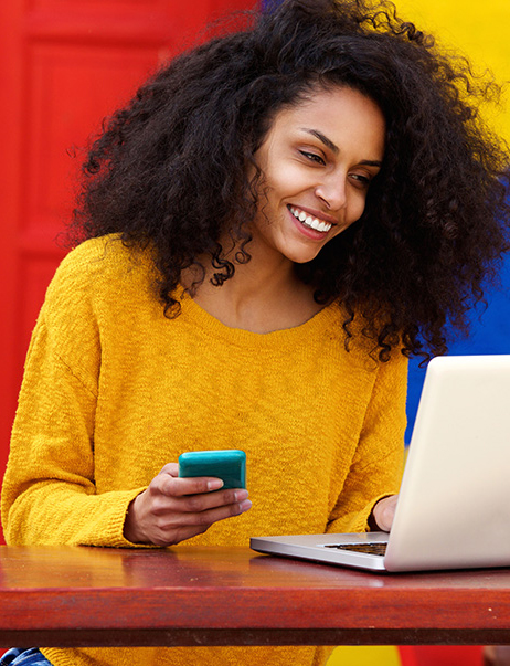 Woman looking at a computer completing her online banking